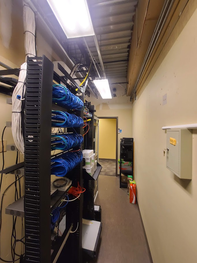 Umbrella Systems technician cabling a school network closet